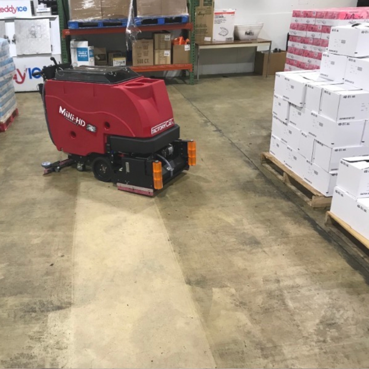 Southern Sweepers MINI-HD from Factory Cat walk-behind scrubber tackling a touch industrial floor.