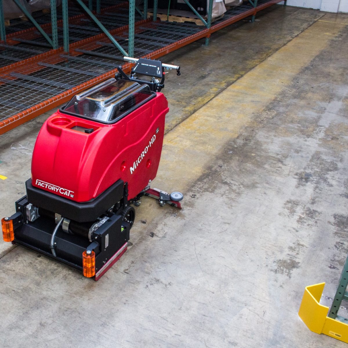 Micro-HD floor scrubber making a clean pathway in a heavy industrial area